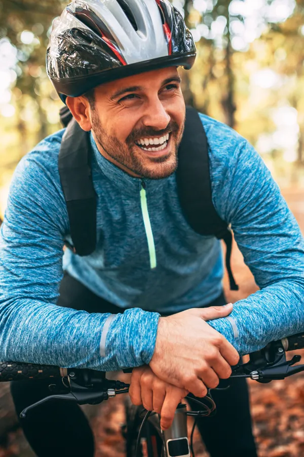 Adrenal-Hormone-Disorder-Treatment A smiling man getting ready for a cycling trip. Get treatment for adrenal hormone disorder from Tanya Zboril, NP of TBT Medical in Halifax.
