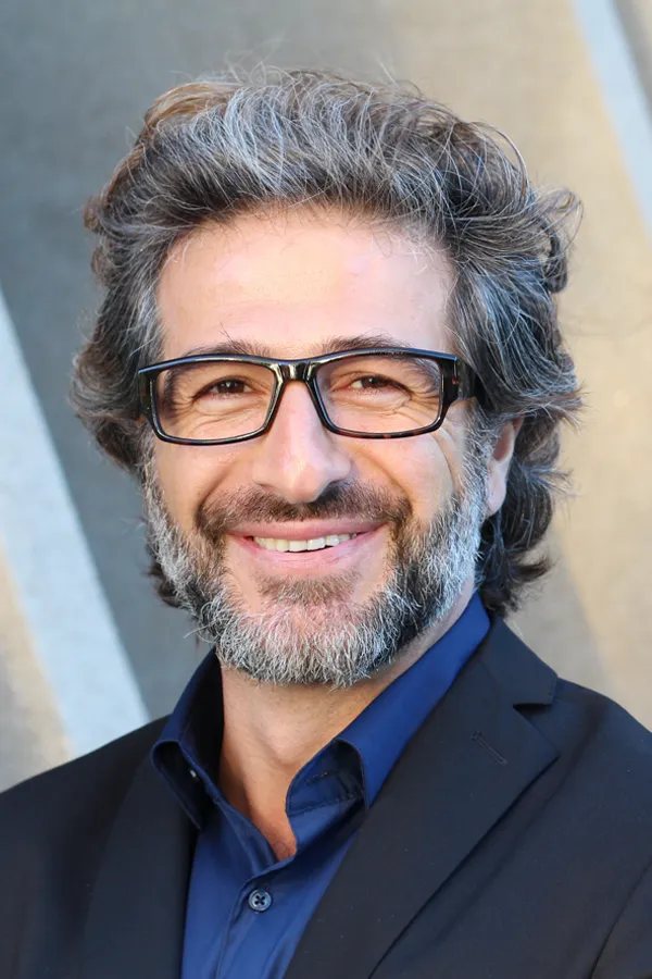 Andropause-and-Low-Testosterone-Treatment A man with glasses, salt and pepper hair and a beard smiling because he received treatment for andropause and low testosterone from Tanya Zboril, NP of TBT Medical in Halifax.