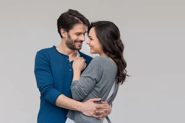 Erectile-Dysfunction-Doctor A man in a blue shirt embracing a woman in a gray shirt smiles due to his successful erectile dysfunction care from Tanya Zboril, NP of TBT Medical in Halifax.