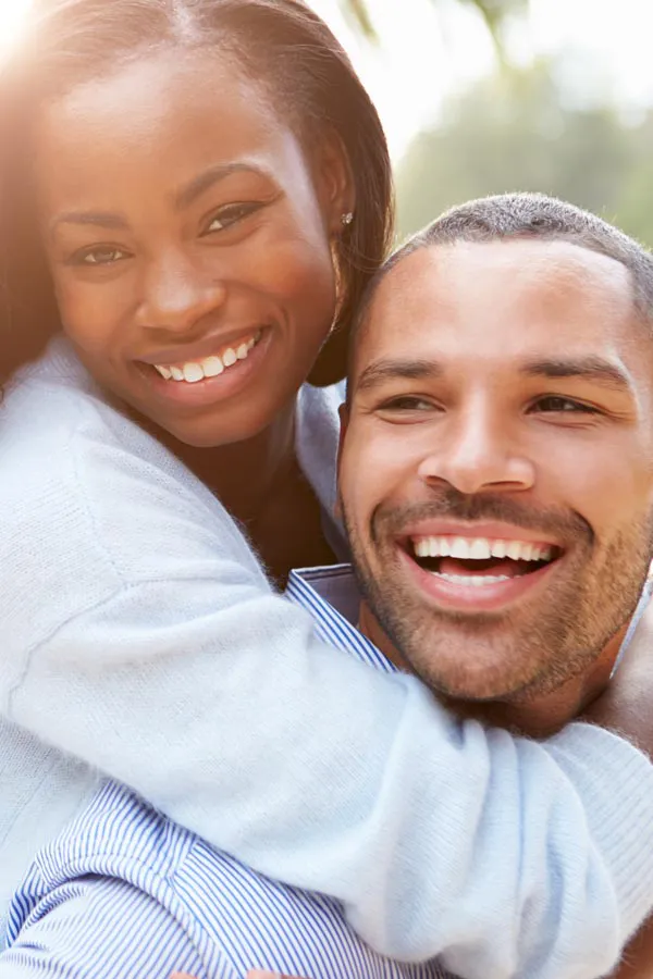 Erectile-Dysfunction-Treatment A woman riding on a man's back, both smiling due to help with erectile dysfunction from Tanya Zboril, NP of TBT Medical in Halifax.