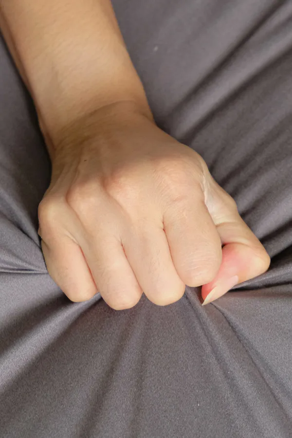 Female-Sexual-Dysfunction-Treatment Close-up of a woman's hand grabbing a sheet, indicating sexual pleasure. Get female sexual dysfunction treatment from Tanya Zboril, NP of TBT Medical in Halifax.
