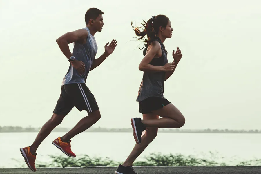 GLP-1-Weight-Loss-Injections-Clinic A couple in profile running along the water. Schedule GLP-1 Weight Loss Injections from Tanya Zboril, NP of TBT Medical in Halifax.