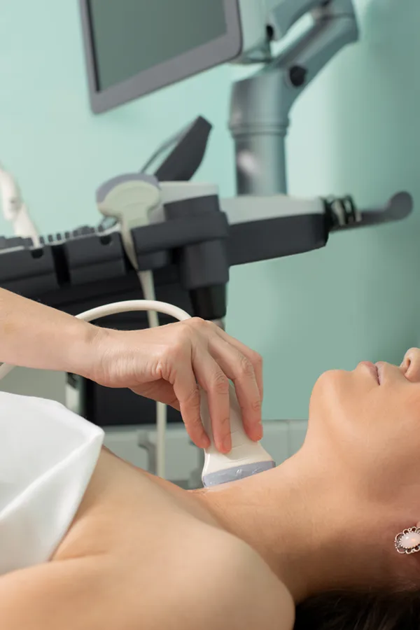 Hashimotos-Thyroiditis-Treatment A woman gets a thyroid scan from a doctor in a clinic. Get help with Hashimoto's Thyroiditis from Tanya Zboril, NP of TBT Medical in Halifax.