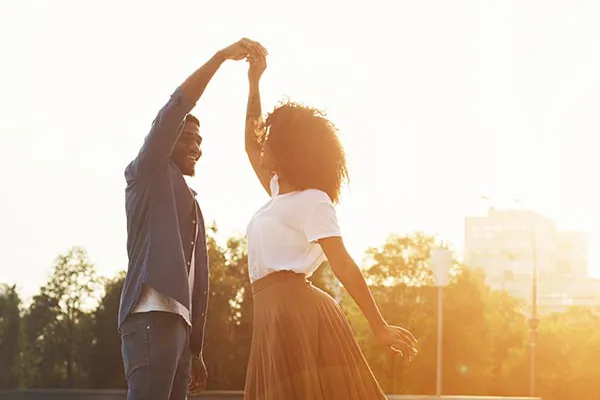 Immunotherapy-Doctor A black couple dances outside lit by the sunset. Get immunotherapy for autoimmune diseases from Tanya Zboril, NP of TBT Medical in Halifax.