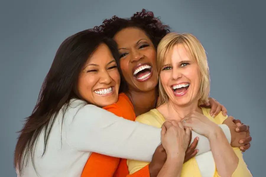 Insulin-Resistance-Clinic An asian, black, and white woman of middle age hug and laugh. Get insulin resistance treatment from Tanya Zboril, NP of TBT Medical in Halifax.