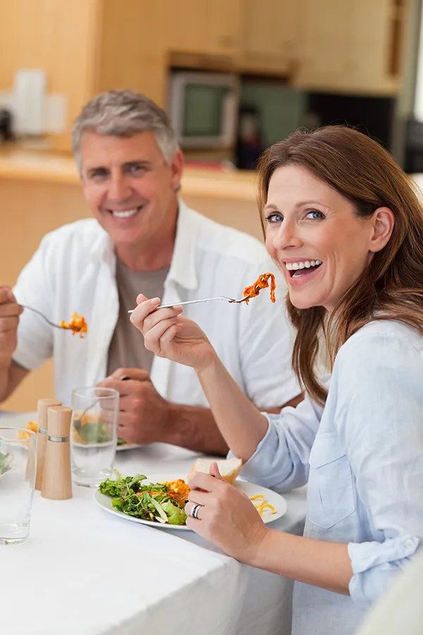 Leaky-Gut-Syndrome-Treatment Improve digestion with Tanya Zboril, NP of TBT Medical's Functional Medicine for Leaky Gut Syndrome care in Halifax, featuring a happy couple enjoying a nutritious lunch at home.