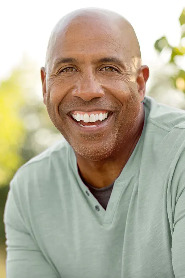 Low-Dose-Naltrexone-Treatment A man in a green shirt sits outside smiling and pain-free. Get low dose naltrexone treatment from Tanya Zboril, NP of TBT Medical in Halifax.