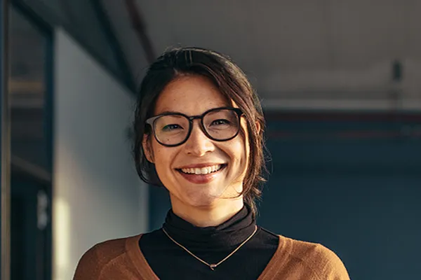Metabolic-Syndrome-Clinic A brunette woman with glasses smiles in a gray-blue walled office. Get metabolic syndrome from Tanya Zboril, NP of TBT Medical in Halifax.