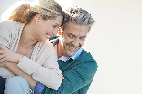 Metformin-Weight-Loss-Clinic A middle-aged couple embrace playfully on a sunny day. Get Metformin for weight loss treatment from Tanya Zboril, NP of TBT Medical in Halifax