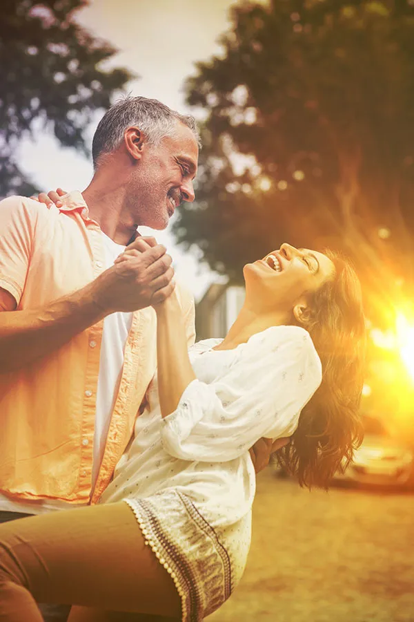 Metformin-Weight-Loss-Treatment A middle-aged couple dances playfully in the woods at sunset. Get Metformin for weight loss treatment from Tanya Zboril, NP of TBT Medical in Halifax