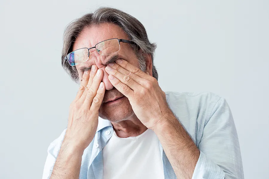 Migraine-Clinic Get migraine relief with Tanya Zboril, NP of TBT Medical's functional medicine for migraines treatment in Halifax, represented by an older man rubbing his eyes due to head pain.