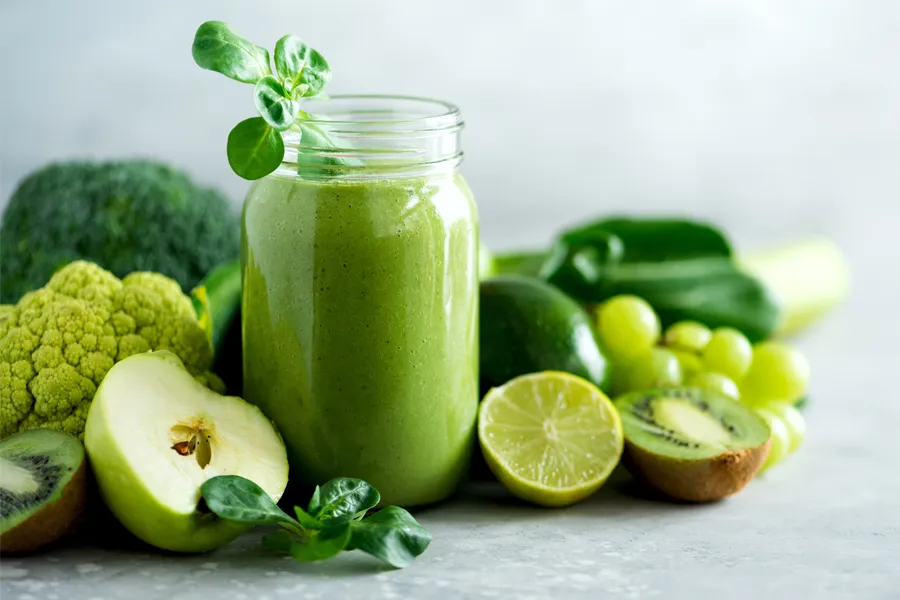 Nutritional-Counseling-Clinic A tableau of healthy green fruits and vegetables and juices. Get nutritional counseling from Tanya Zboril, NP of TBT Medical in Halifax.